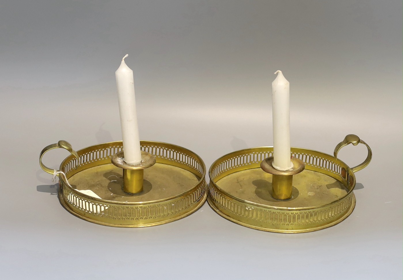 A pair of 19th century circular brass chambersticks, diameter 18cm